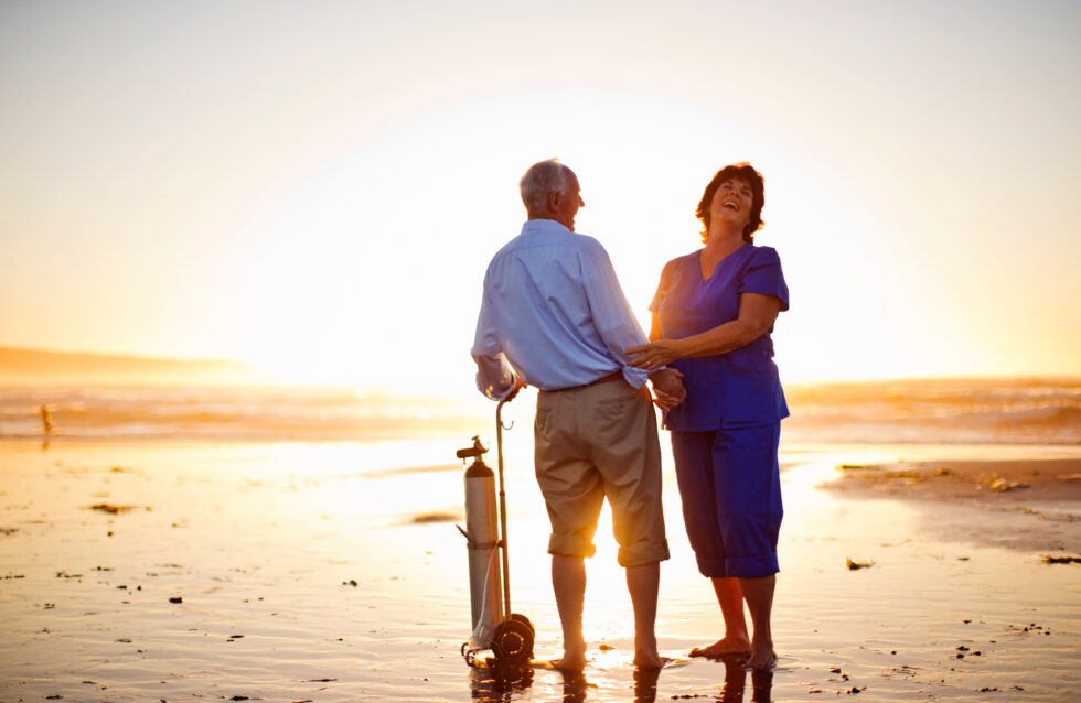 a man and woman standing on a beach